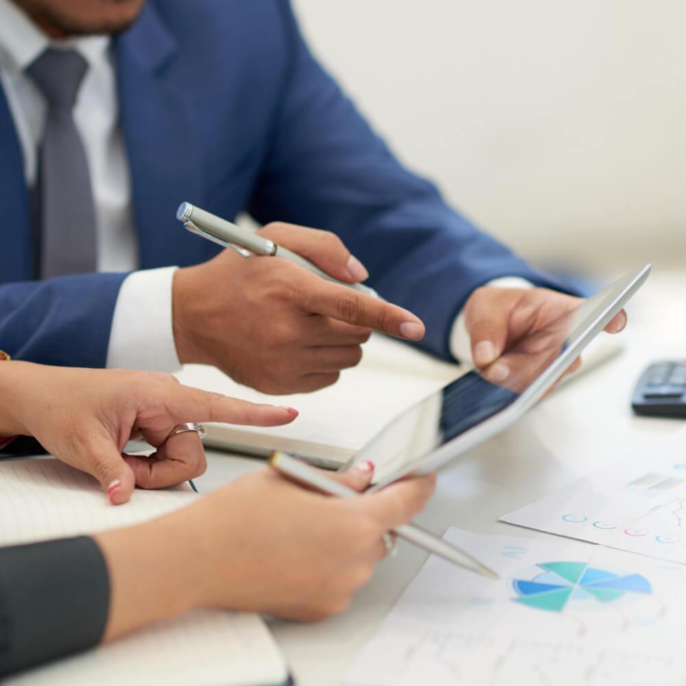 Advisers reviewing business documents together