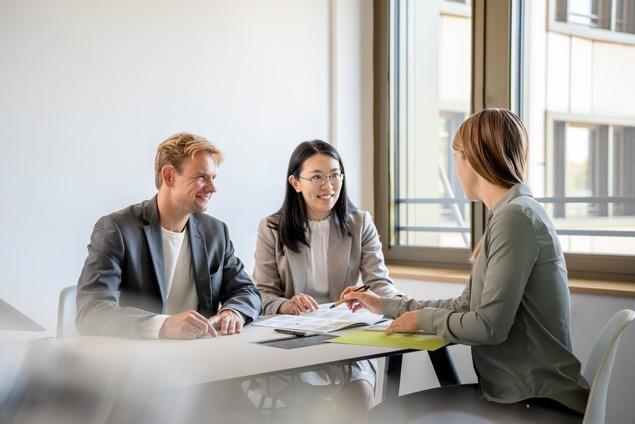 Clients discussing their plans with an adviser