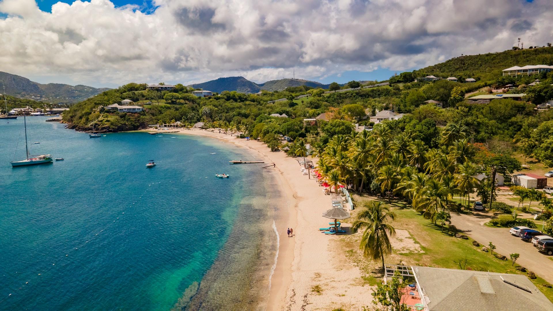 Aerial view of white sand beaches and green coastline beside turquoise water in Antigua and Barbuda