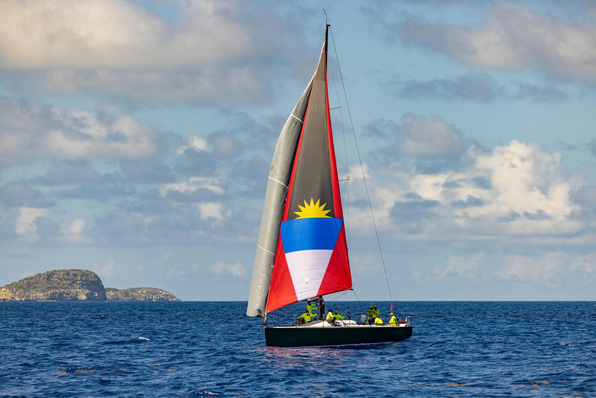 Sailing boat displaying Antigua and Barbuda flag colours during Race Week