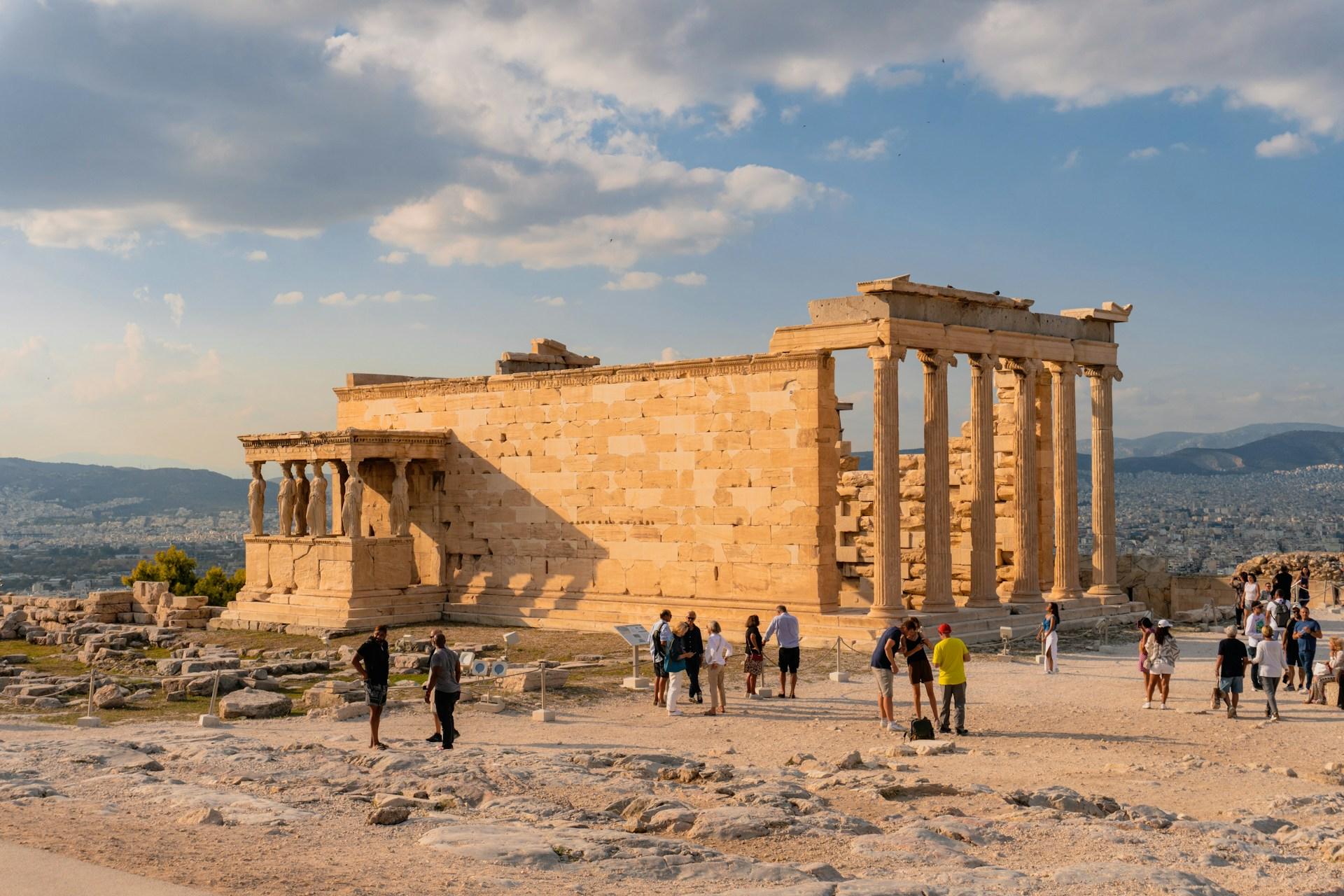 Visitors beside the Erechtheion at the Acropolis in Athens, Greece
