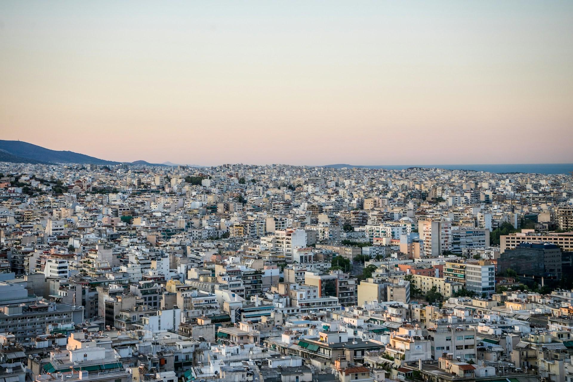 Athens city panorama with residential and commercial buildings at dusk