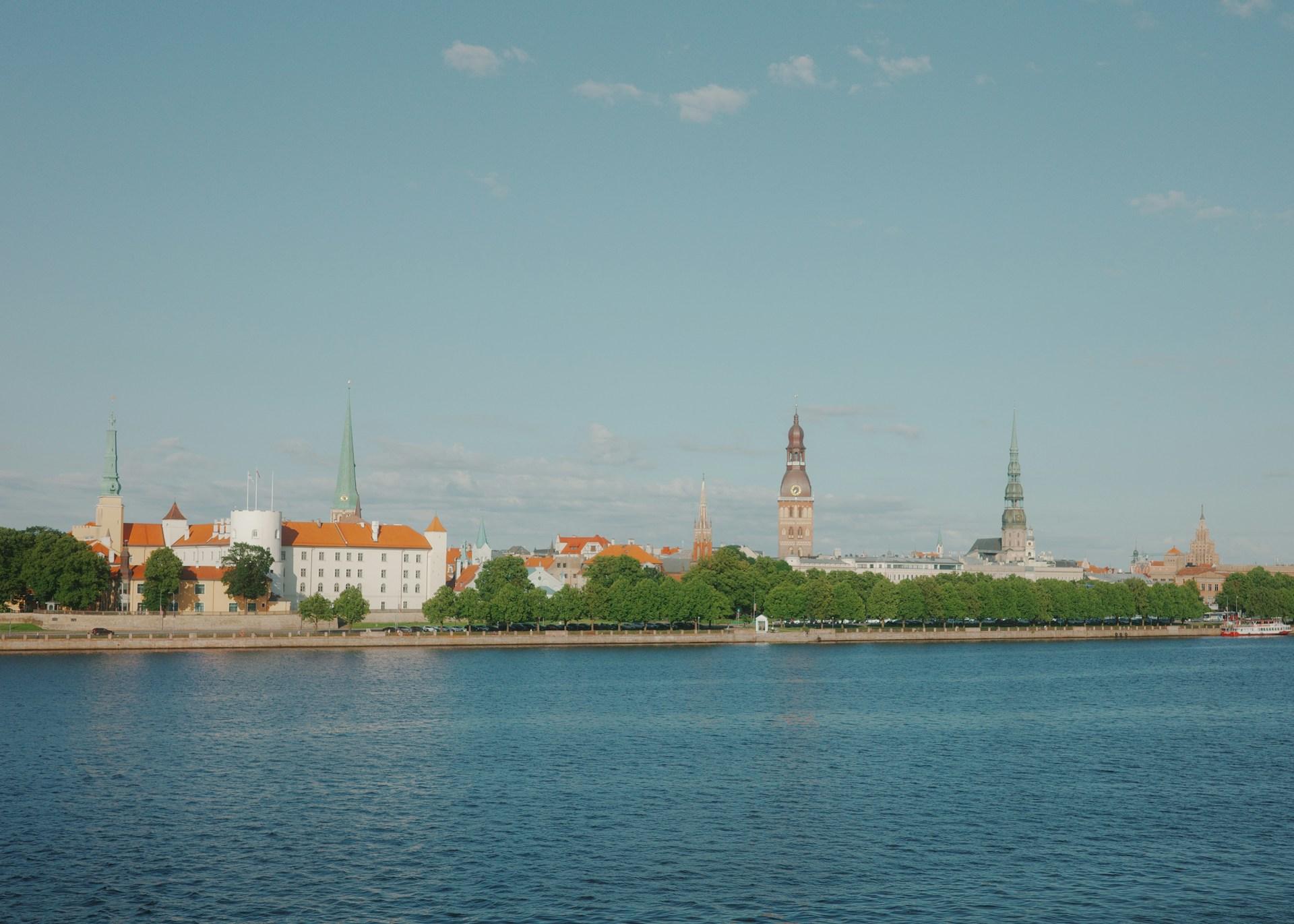 Riga Old Town skyline and church spires beside the Daugava River in Latvia