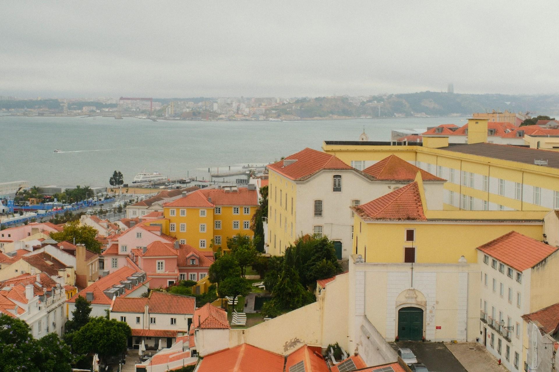 Red-roofed houses and historic buildings overlooking the Tagus River in Lisbon, Portugal