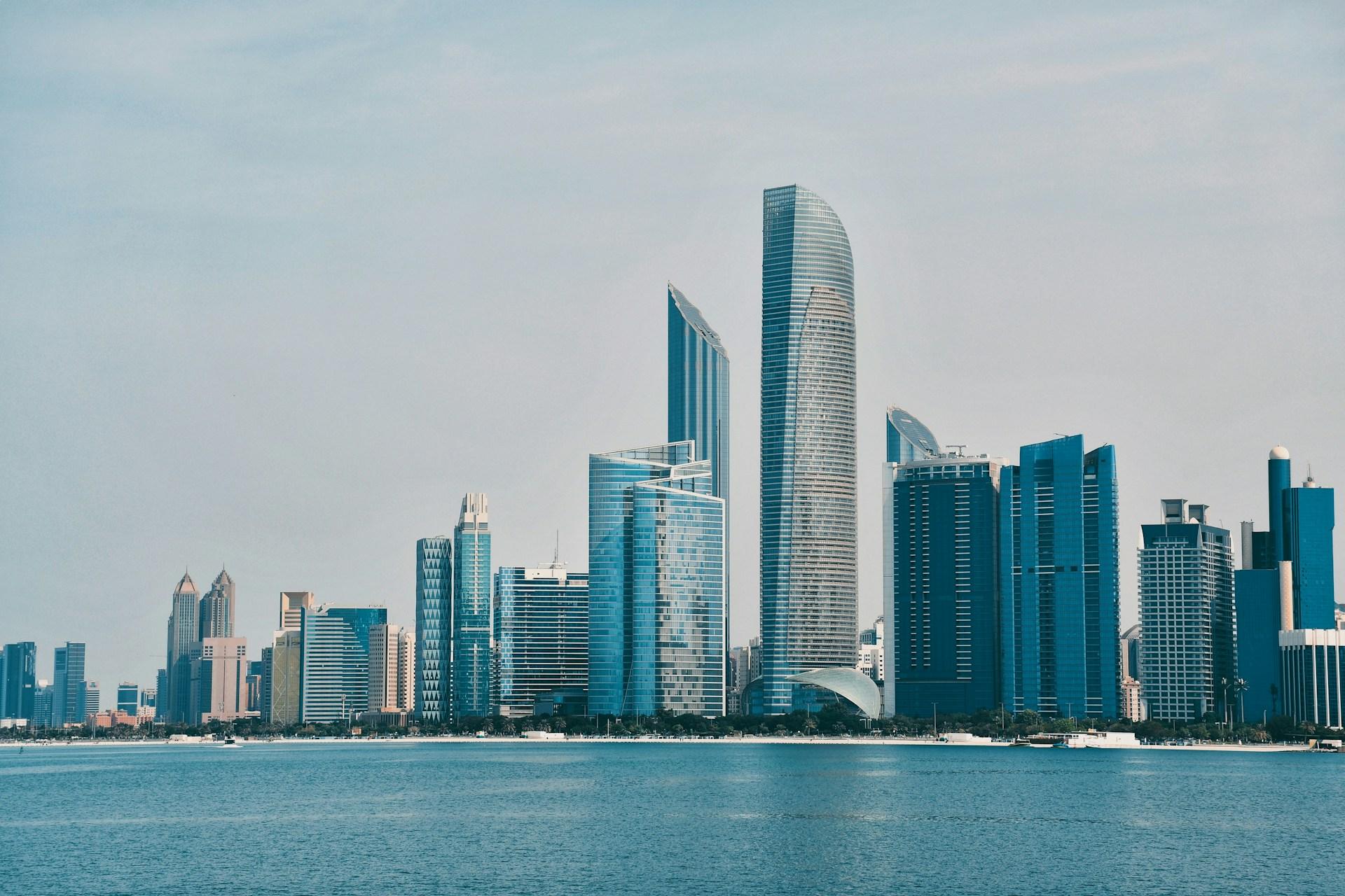 Modern Abu Dhabi skyline beside the blue water of the Corniche